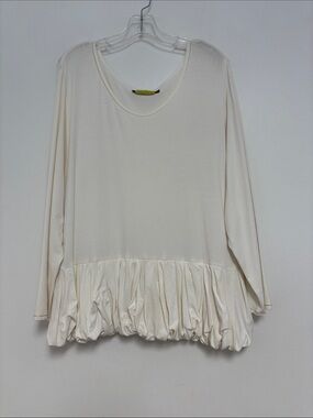 Giselle Shepatin cream, long-sleeve top with a distinctive bubble peplum hem